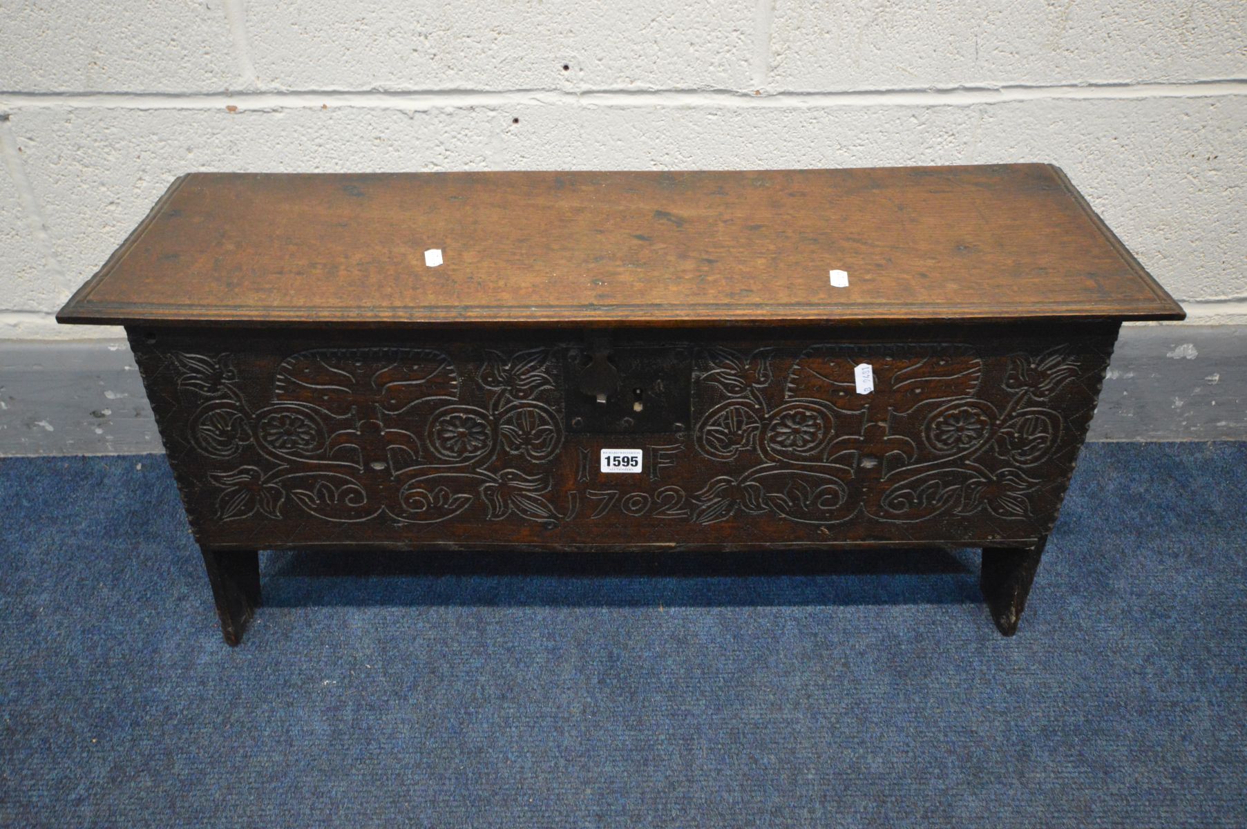 AN EARLY 18TH CENTURY OAK SIX PLANK BOARDED CHEST, with a moulded edge and iron hinged lid, and