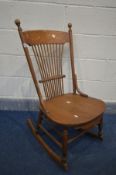 AN ARTS AND CRAFTS SPINDLE BACK ROCKING CHAIR