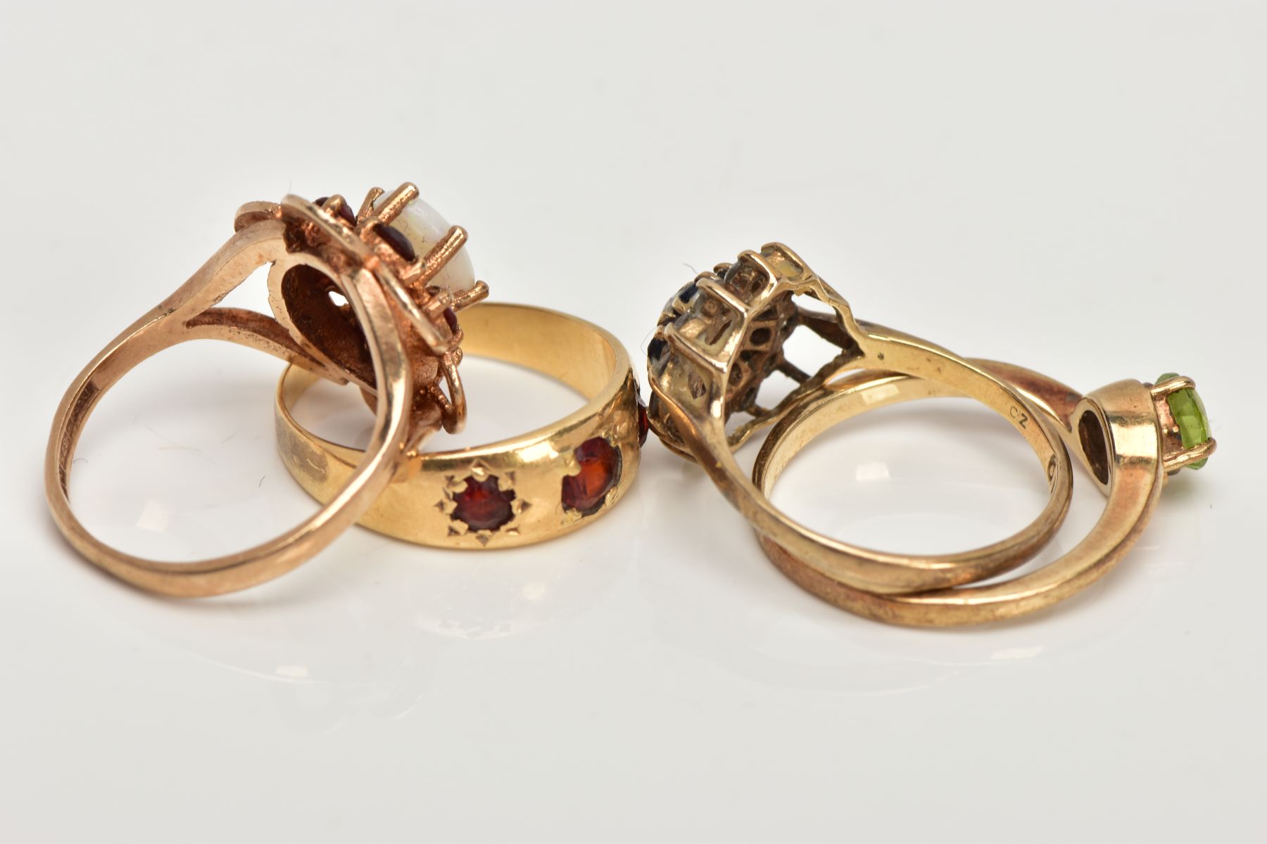 FOUR 9CT GOLD GEM SET RINGS, to include a sapphire and cubic zirconia cluster ring, a cross over - Image 3 of 3