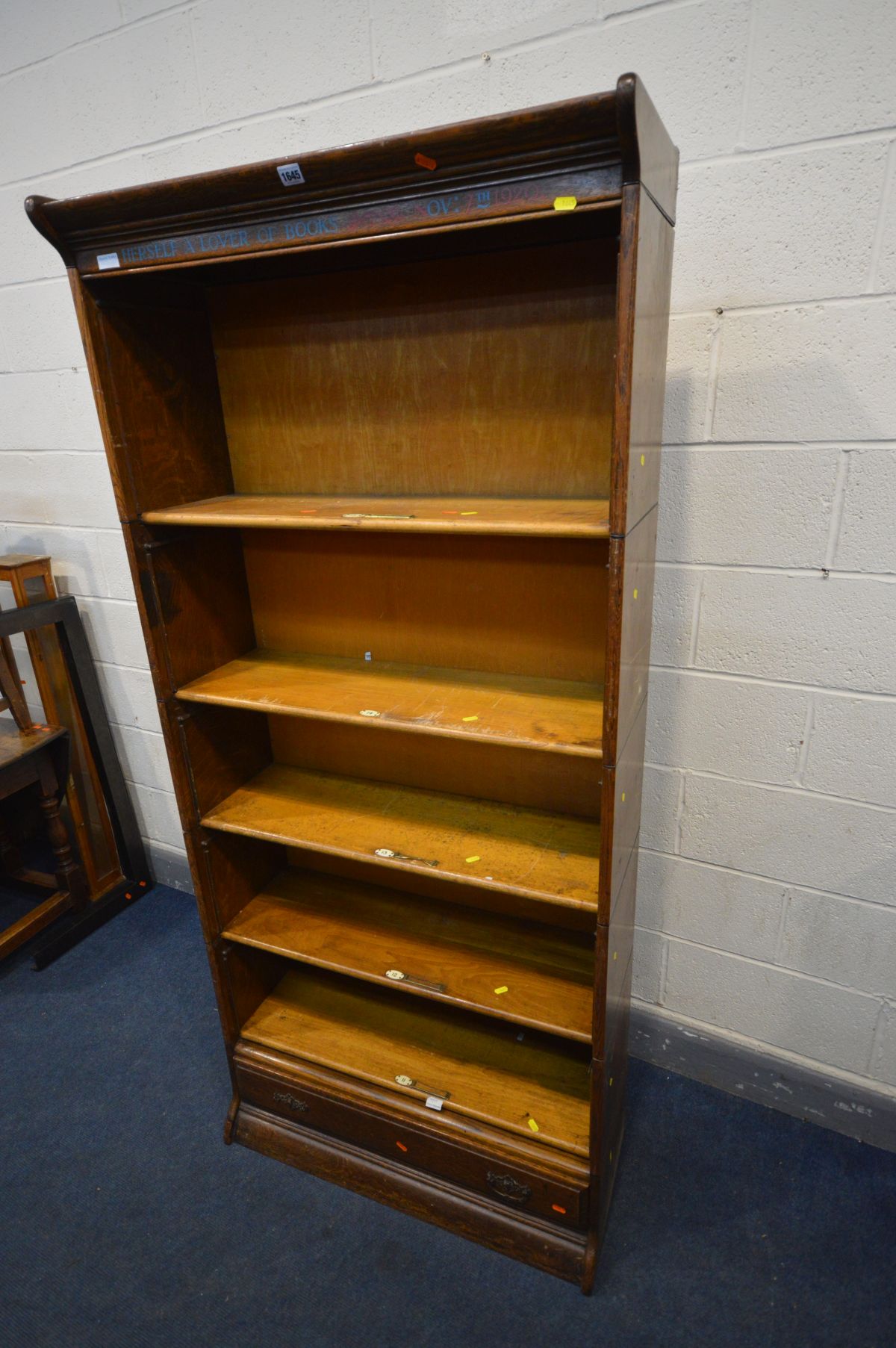 AN OAK FIVE SECTION BOOKCASE, with stencilled writing to top frieze, the bottom section with a - Image 2 of 3