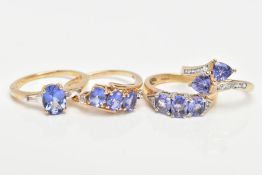 FOUR 9CT GOLD TANZANITE DRESS RINGS, each set with various cut tanzanite's, also each ring is