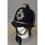 A STAFFORDSHIRE POLICE HELMET, black fabric covering, the interior lining partly perished