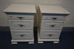 A PAIR OF WHITE THREE DRAWER BEDSIDE CABINETS, the top drawers with a pull out glass surface, on