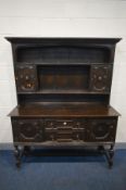 AN EARLY 20TH CENTURY OAK DRESSER, with an assortment of geometric drawers and cupboard doors, width