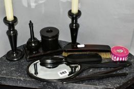 AN EBONY DRESSING TABLE SET, comprising candlesticks height approximately 15cm, clothes brush,