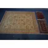 A FLORAL WOOLLEN RUG, labelled Abbey, 240cm x 170cm and two small tekke rugs, in a red field (3)