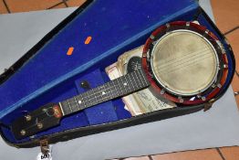 A RELIANCE UKELELE-BANJO IN A CARRY CASE, comes with a small quantity of sheet music