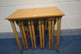 IN THE MANNER OF POUL HUNDEVAD, a mid-century teak nesting tables, with four fold out tables