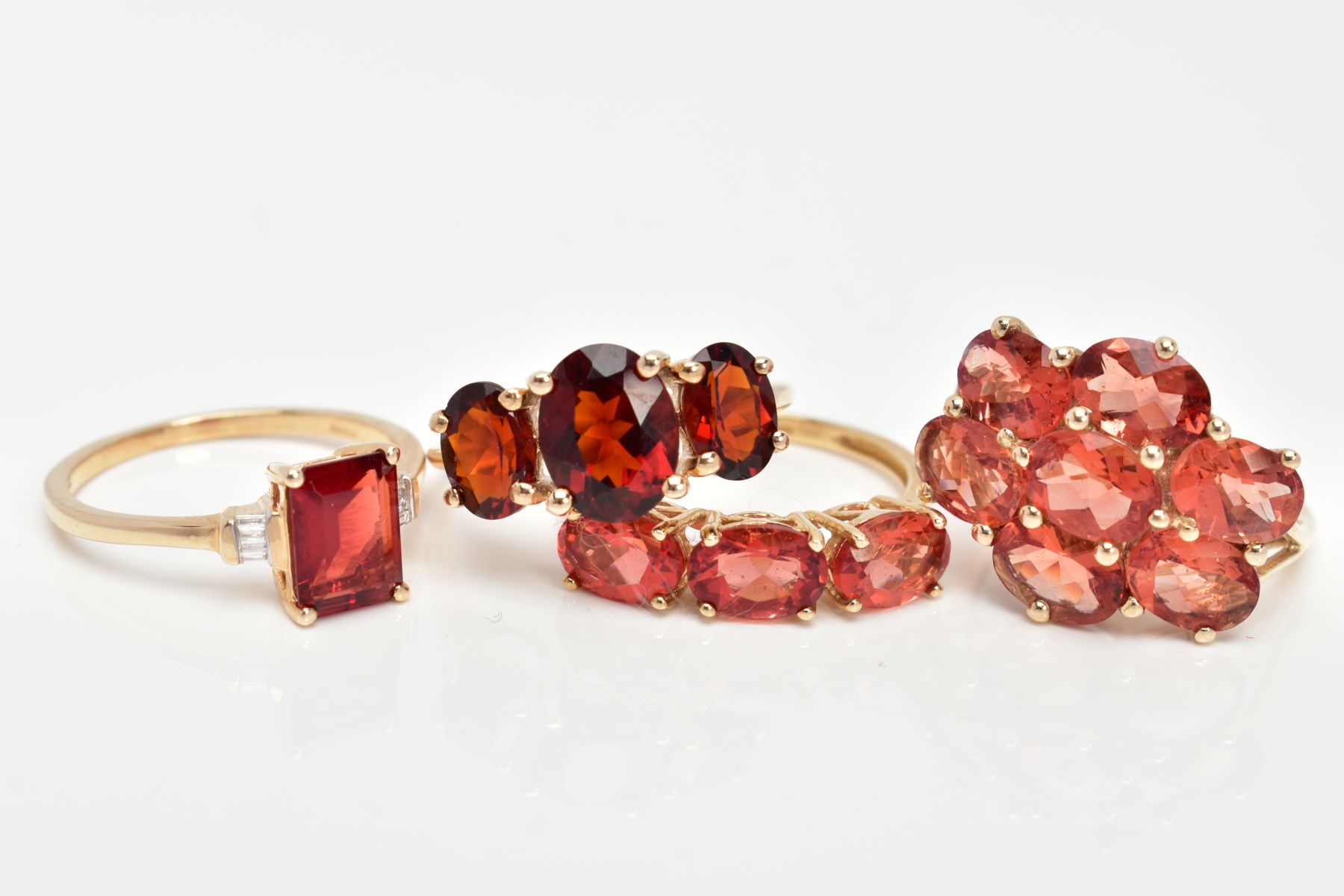FOUR 9CT GOLD GEM SET RINGS, set with orange and red gemstones possibly Andesine, each with a 9ct - Image 2 of 3