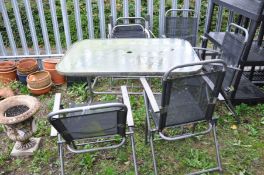 A RECTANULAR GARDEN TABLE WITH TUBULAR METAL BASE and glass top along with six similar chairs (7)