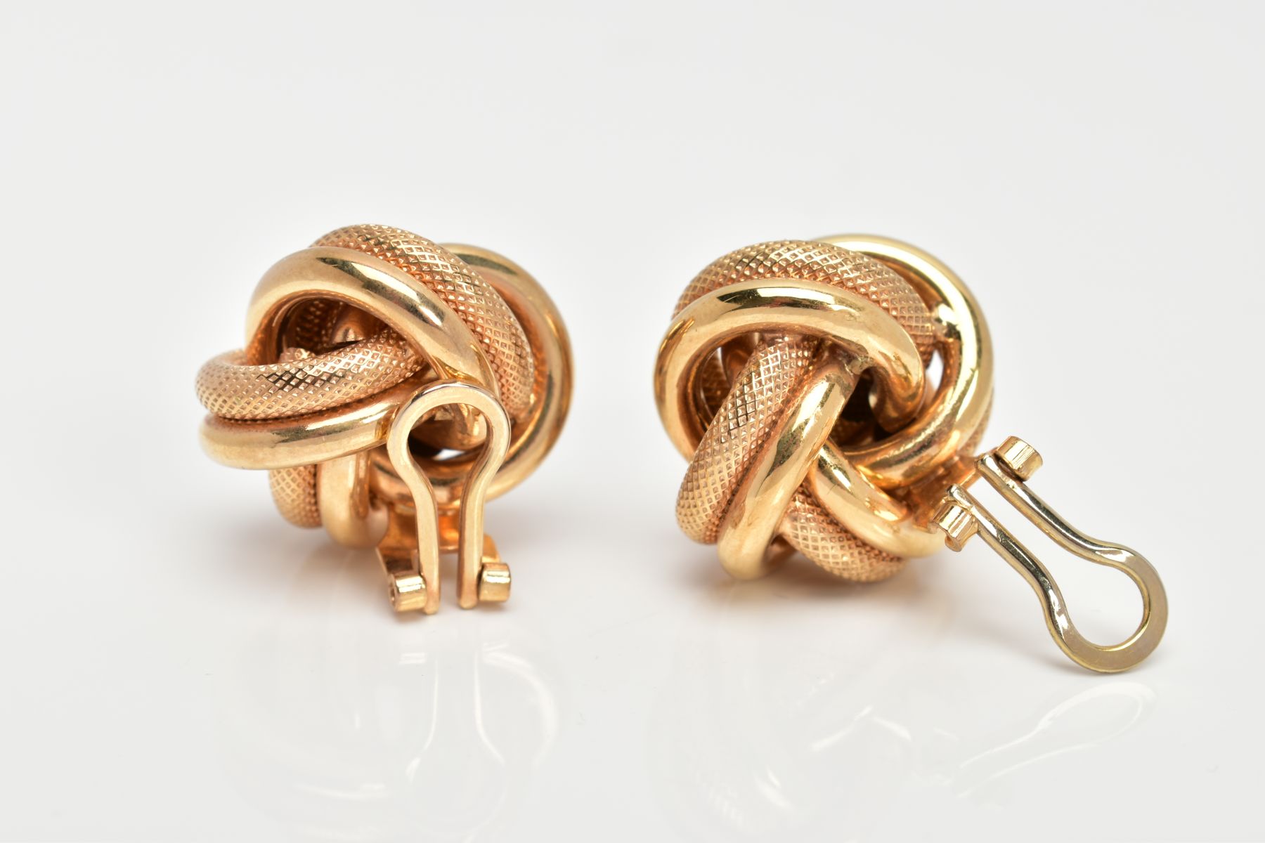 A PAIR OF YELLOW METAL KNOT EARRINGS, textured and non-textured intertwined knots, fitted with non- - Image 2 of 3