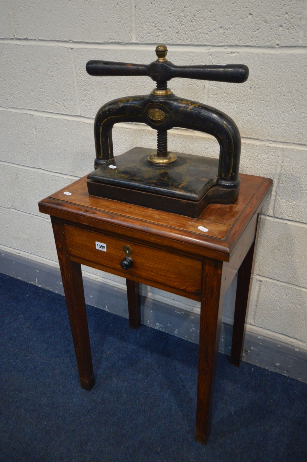 A VINTAGE CAST IRON BOOKPRESS, with a label reading William Mitchell, Birmingham & London, on a