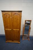 A PINE DOUBLE DOOR WARDROBE, width 93cm x depth 62cm x height 184cm (key) and a pine cheval