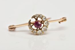 A YELLOW METAL, DIAMOND AND RUBY BROOCH, designed with a crescent, set with graduated old cut