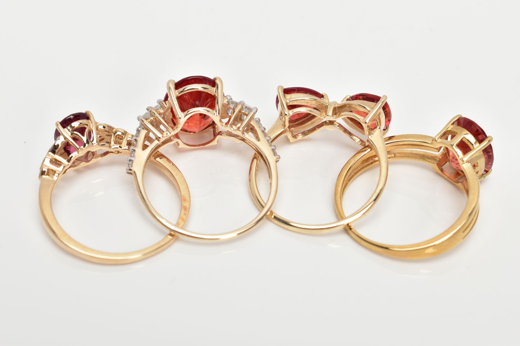 FOUR 9CT GOLD GEM SET RINGS, each set with orangish red stones, assessed as garnet and Oregan - Image 3 of 3