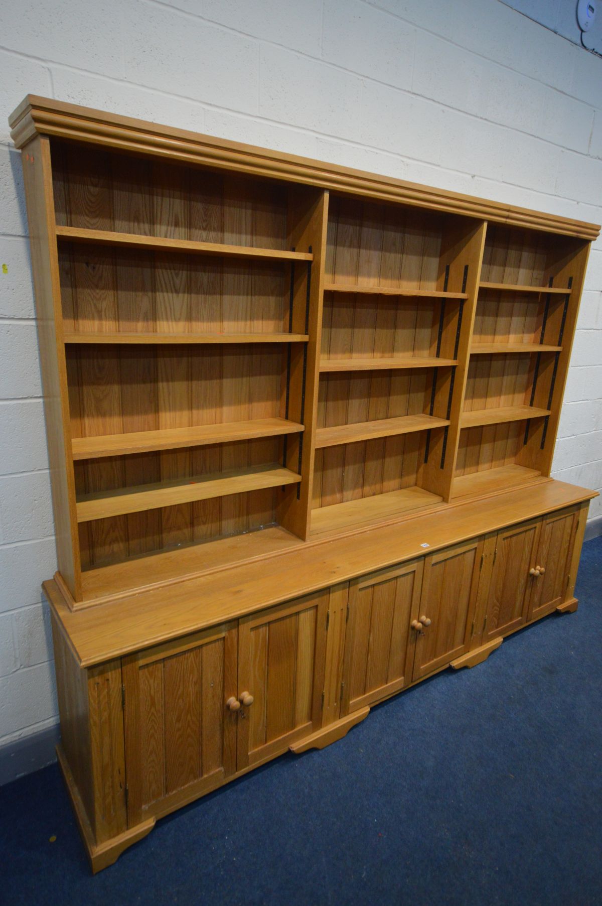 A LARGE LIMED OAK BOOKCASE, the three division top section with twelve adjustable shelves, above - Image 2 of 3