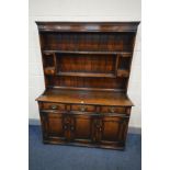 A TITCHMARSH AND GOODWIN OAK DRESSER, with three frieze drawers and triple fielded panel cupboard