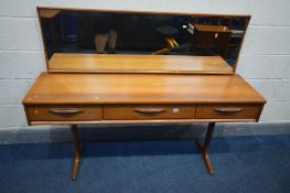 AN AUSTINSUITE TEAK DRESSING TABLE, with a long rectangular mirror, three frieze drawers, on twin