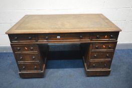 A VICTORIAN OAK PEDESTAL DESK, with a brown tooled leather inlay, and nine assorted drawers, on