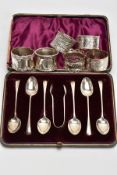 A CASED SET OF SILVER TEASPOONS AND SIX NAPKIN RINGS, the cased set comprising of six rat tail