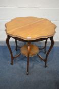 AN EARLY 20TH CENTURY WALNUT CENTRE TABLE, with a wavy edge top, on shaped legs united by a