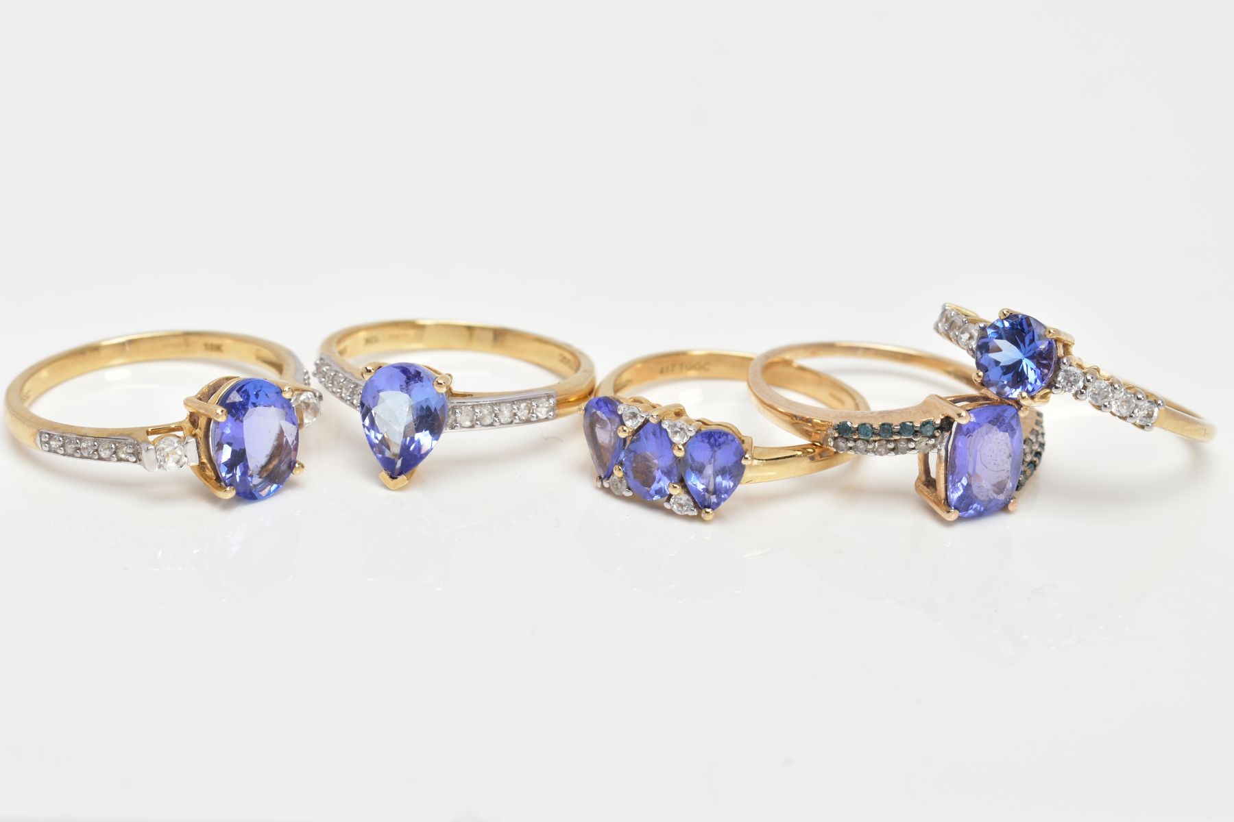 FIVE 9CT GOLD TANZANITE DRESS RINGS, vary cut tanzanite's, also flanked with either colourless - Image 2 of 3