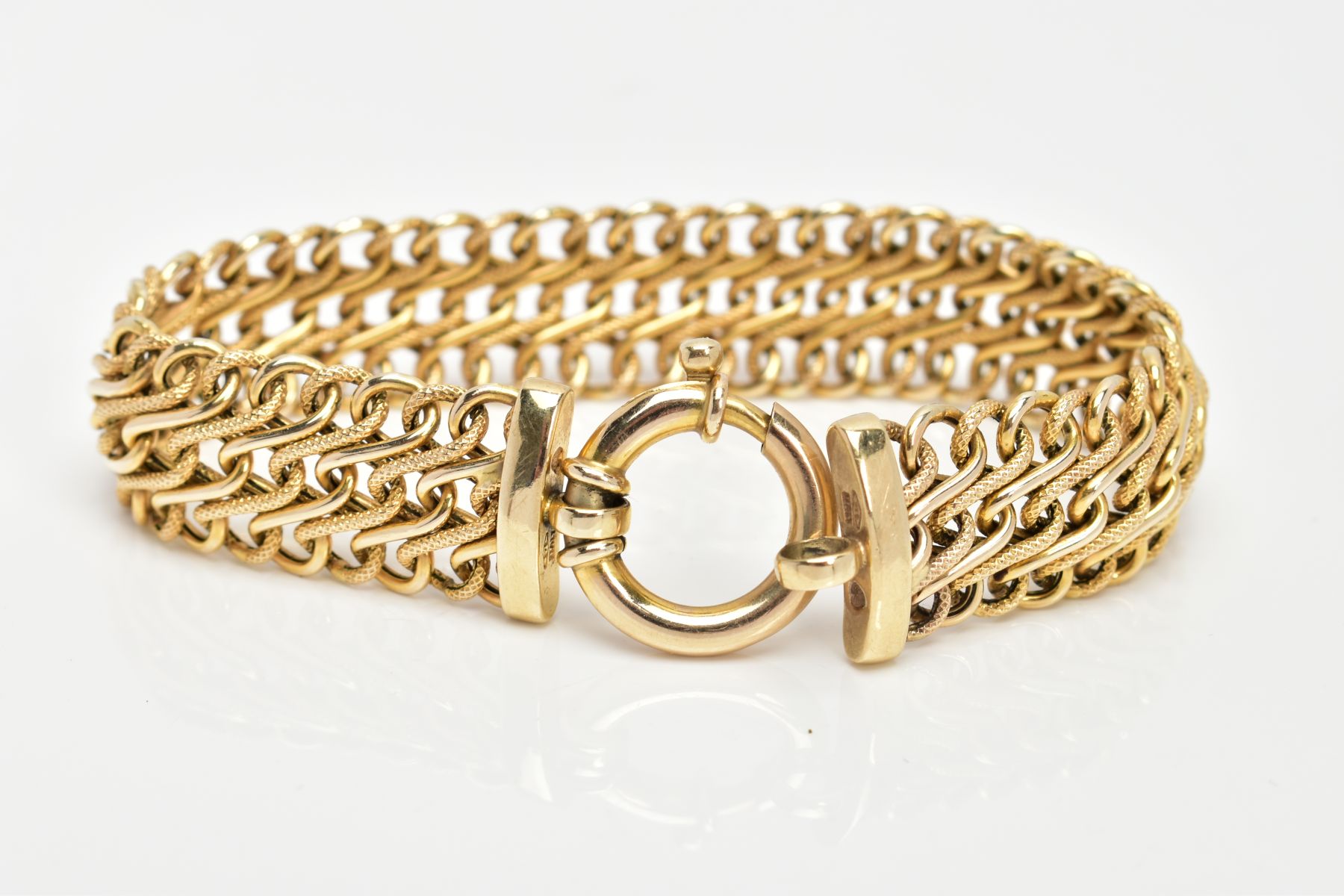 A 9CT GOLD BRACELET, wide bracelet of interlocking 'S' links, alternating textured and none textured - Image 2 of 2