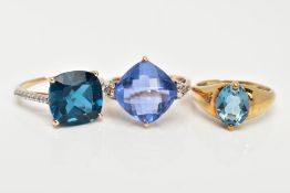 THREE 9CT GOLD GEM SET DRESS RINGS, each set with a vary cut blue stone possibly topaz/fluorite