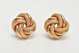 A PAIR OF YELLOW METAL KNOT EARRINGS, textured and non-textured intertwined knots, fitted with non-