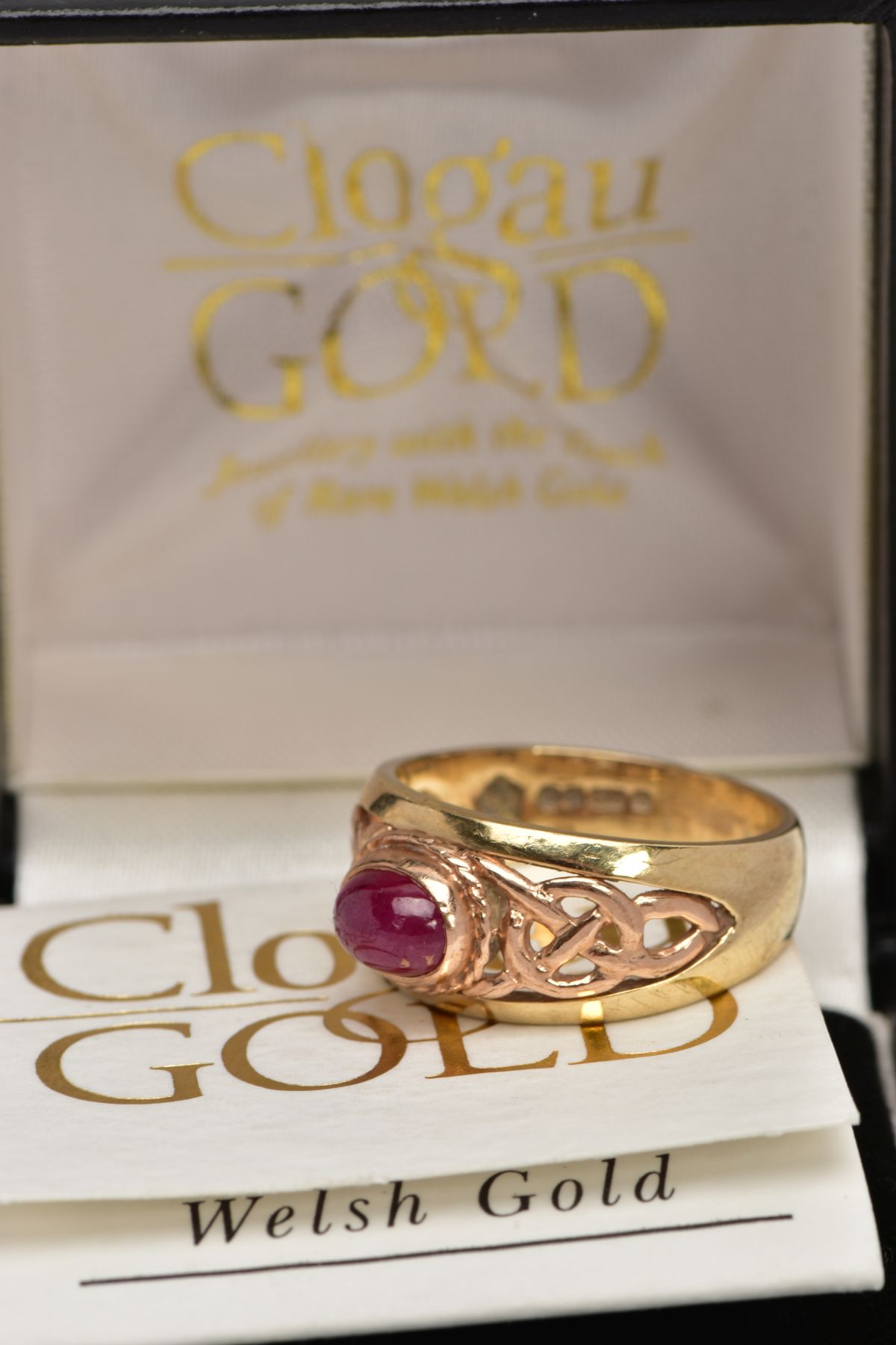 A 9CT GOLD 'CLOGAU' SIGNET RING, designed with a central oval ruby cabochon, collet mount with a - Image 5 of 5