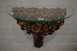 A GILT RESIN ROSE HEAD DECORATED CONSOLE TABLE, with a glass top, width 71cm x height 78cm