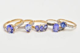 FIVE 9CT GOLD TANZANITE DRESS RINGS, vary cut tanzanite's, also flanked with either colourless