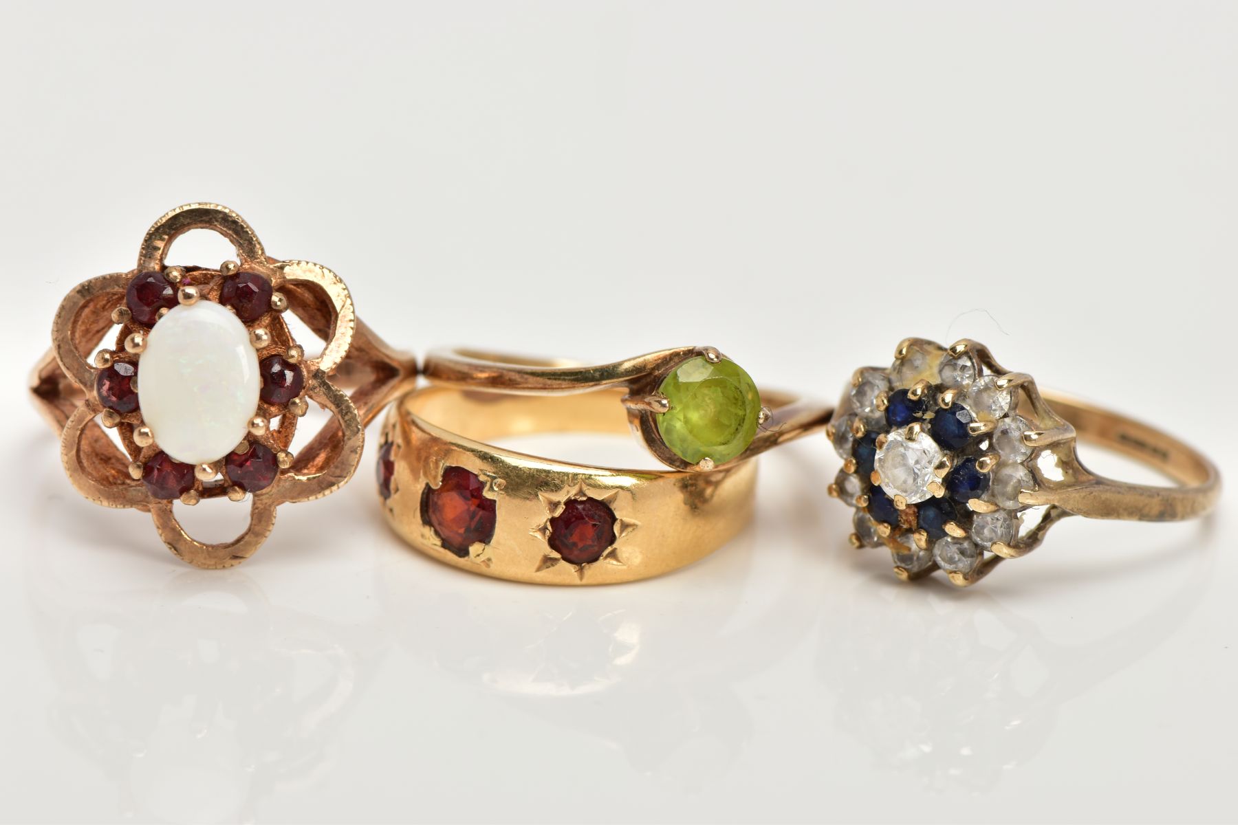 FOUR 9CT GOLD GEM SET RINGS, to include a sapphire and cubic zirconia cluster ring, a cross over - Image 2 of 3