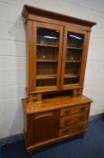 A LATE VICTORIAN PINE SIDEBOARD with a later glazed bookcase top, an arrangement of drawers and a