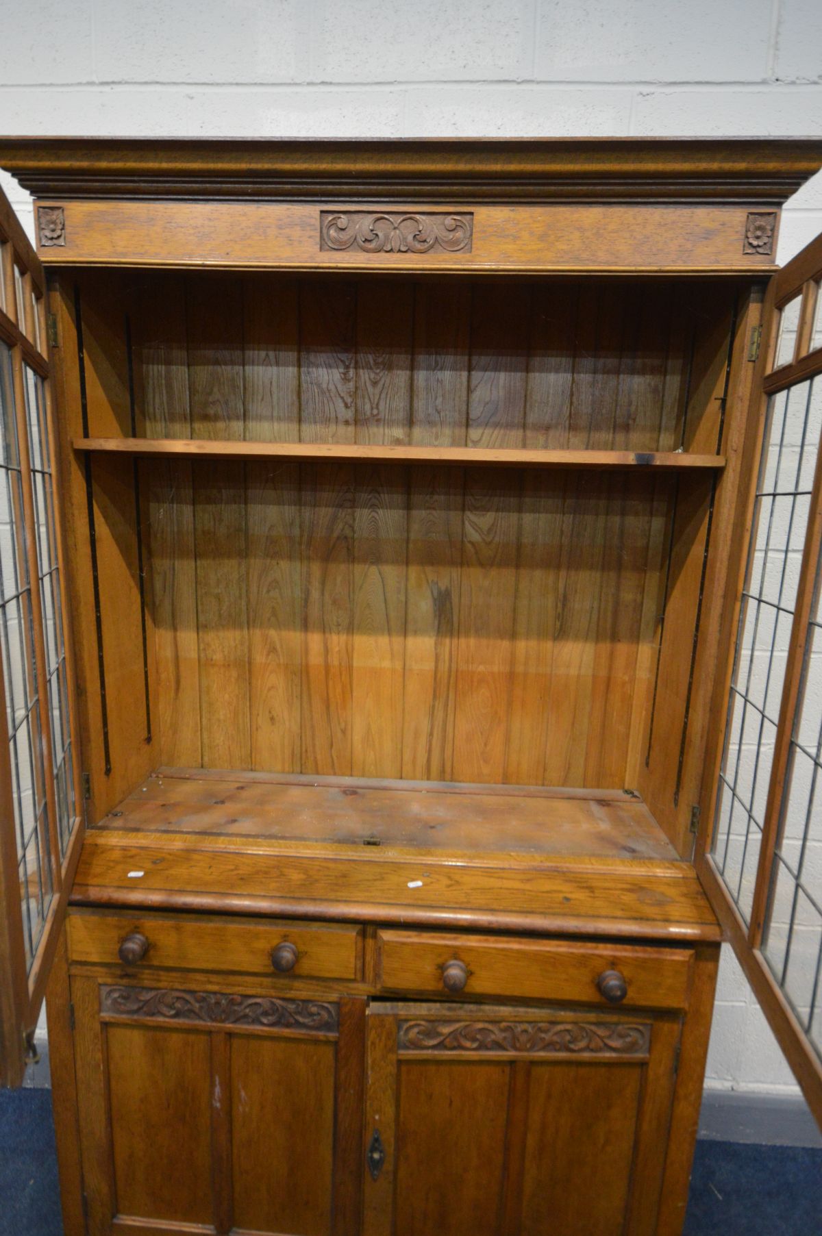 AN EARLY 20TH CENTURY ARTS AND CRAFTS OAK TWO DOOR LEAD GLAZED BOOKCASE, with two drawers, over - Image 3 of 5