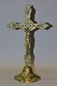 A VICTORIAN BRASS CRUCIFIX ON SHAPED CIRCULAR PEDESTAL BASE, approximate height 33cm x width 19cm,