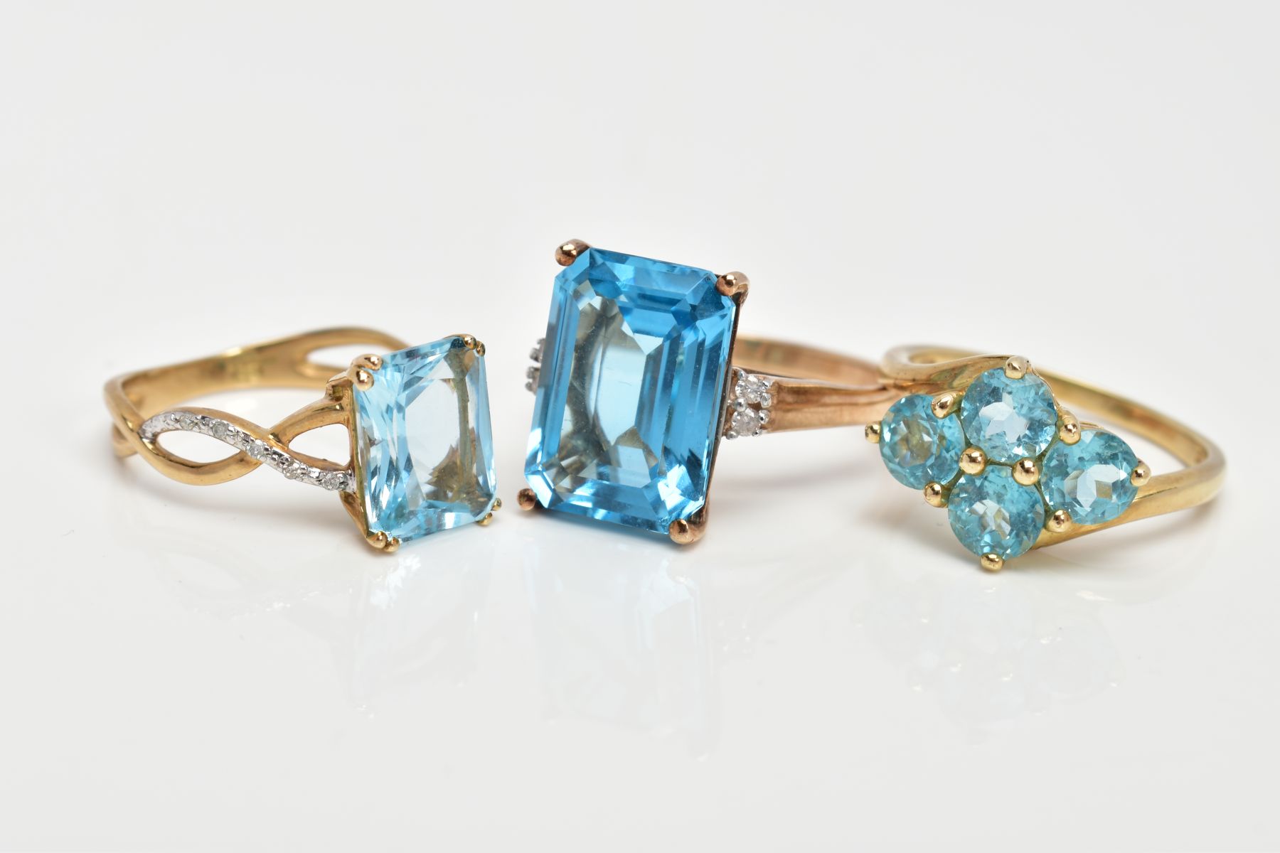 THREE 9CT GOLD TOPAZ DRESS RINGS, the first designed with a rectangular cut blue topaz, flanked with - Image 2 of 3