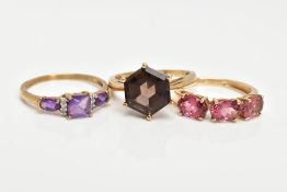 TWO 9CT GOLD GEM SET RINGS AND A YELLOW METAL AMETHYST AND DIAMOND RING, the first set with a