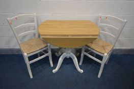A PARTIALLY PAINTED AND LIGHT OAK DROP LEAF PEDESTAL TABLE, and two rush seated chairs (3)