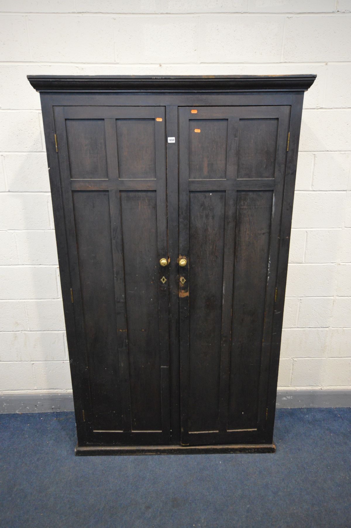AN EARLY 20TH CENTURY STAINED PINE CUPBOARD, with double panelled doors enclosing ten divisions,