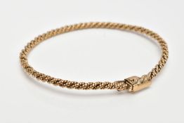 A 9CT GOLD BANGLE, of rope twist sprung design, with push piece clasp and figure of eight safety