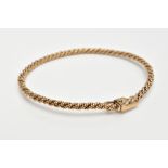 A 9CT GOLD BANGLE, of rope twist sprung design, with push piece clasp and figure of eight safety