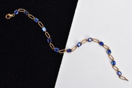 A 9CT GOLD KYANITE SET LINE BRACELET, designed with thirteen oval cut kyanites, interspaced with