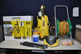 A KARCHER K4 PRESSURE WASHER with patio head, lance and pipe, 2 attachments, bottle of stone and