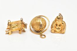 THREE CHARMS, to include a rotating globe, a Buddha and an oriental charm, all stamped 14k,