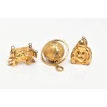 THREE CHARMS, to include a rotating globe, a Buddha and an oriental charm, all stamped 14k,