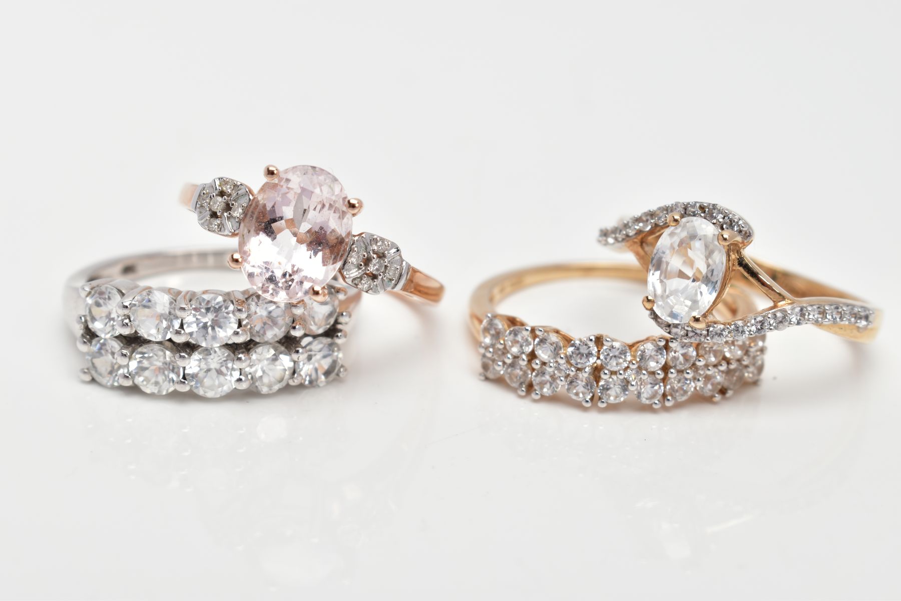 FOUR 9CT GOLD DRESS RINGS, the first a rose gold ring set with an oval cut morganite, flanked with