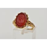 A 9CT GOLD CAMEO RING, oval cameo depicting a lady in profile, carved into possibly carnelian,