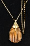 A LARGE ABSTRACT TIGERS EYE 9CT GOLD PENDANT AND CHAIN, a carved pear shape tigers eye stone