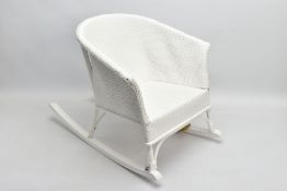 A CHILDS LLOYD LOOM TYPE WHITE OVERPAINTED MUSICAL ROCKING CHAIR, height 44cm x width 44cm x depth